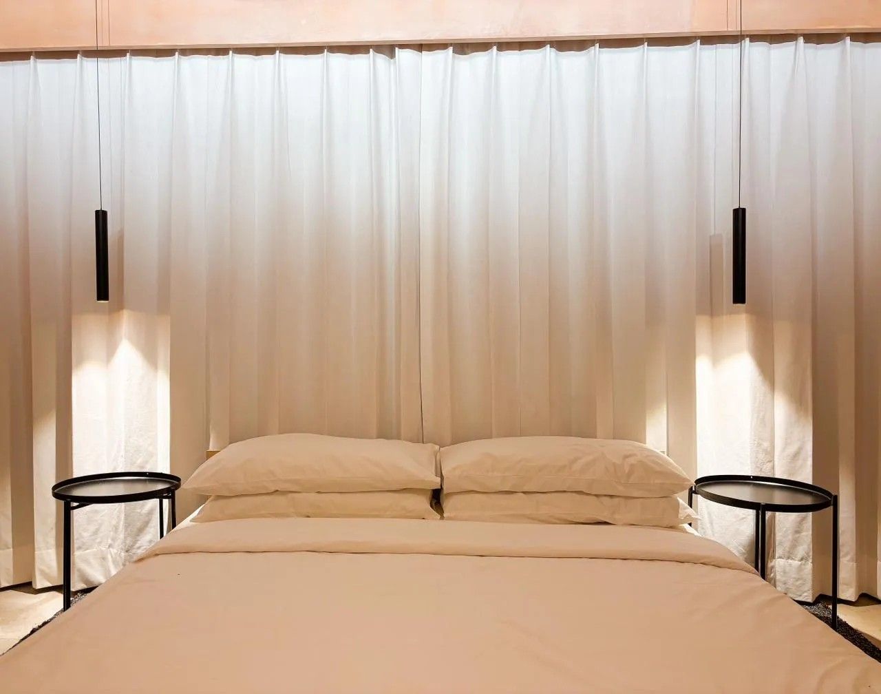 Bed with pendant lights and side tables