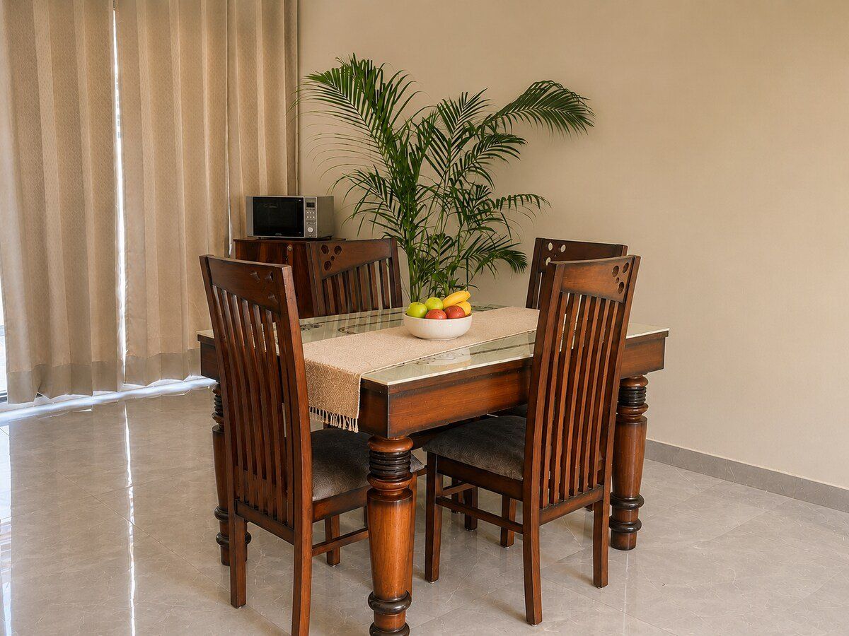 Wooden dining table for four with a fruit bowl