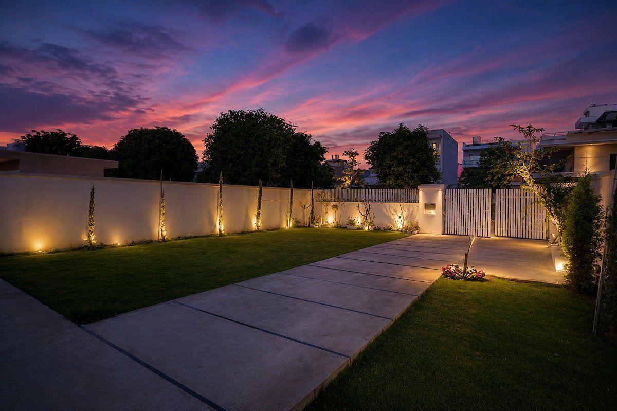 Stone path across the lawn with garden lights under an evening sky