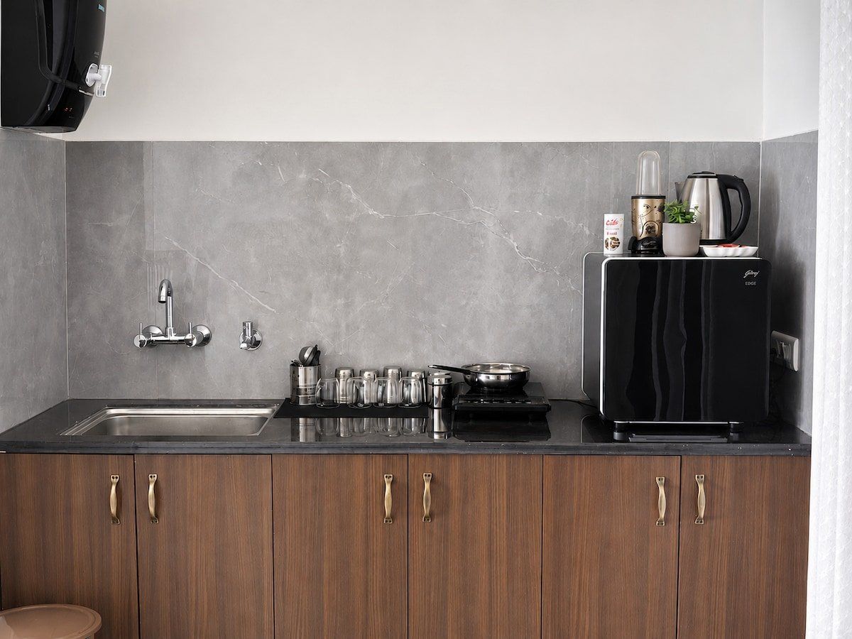 Kitchen counter with sink, induction hob, kettle and microwave